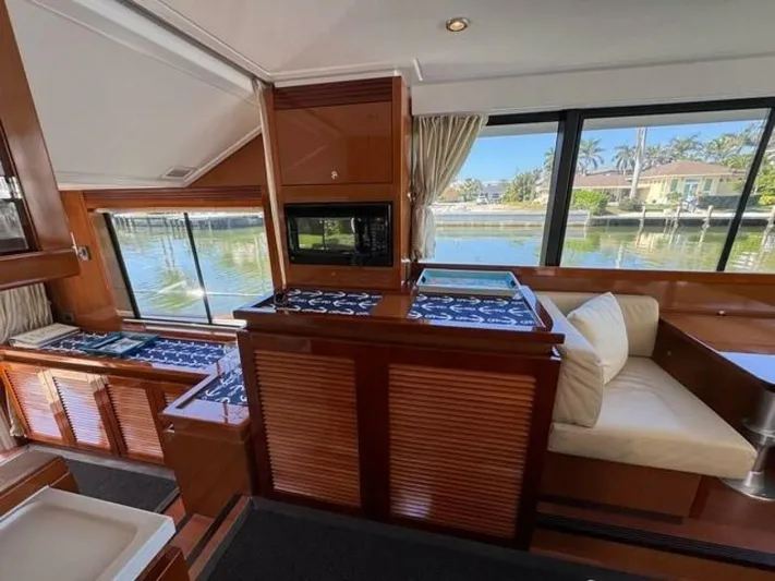 Candy Girl Yacht Photos Pics Interior of 2017 Beneteau Swift Trawler 50 with elegant wood finish and waterfront view.