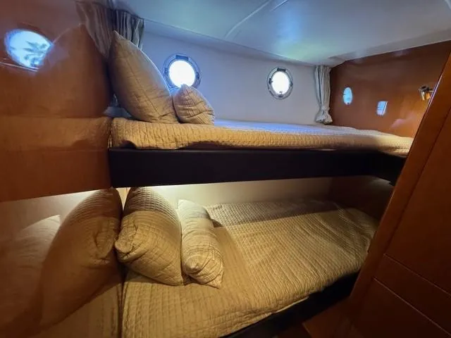 Candy Girl Yacht Photos Pics 2017 Beneteau Swift Trawler 50 cabin with cozy bunk beds and porthole windows.