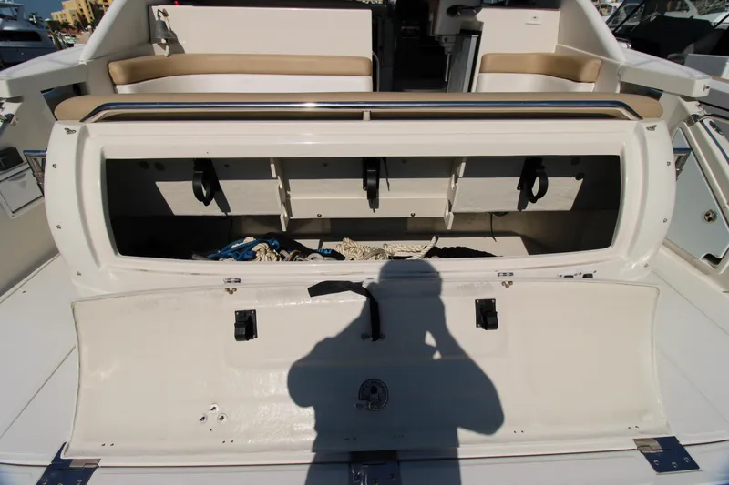 Long Overdue Yacht Photos Pics Open storage compartment on a 2002 Regal Commodore 4260 boat, showing ropes and accessories.