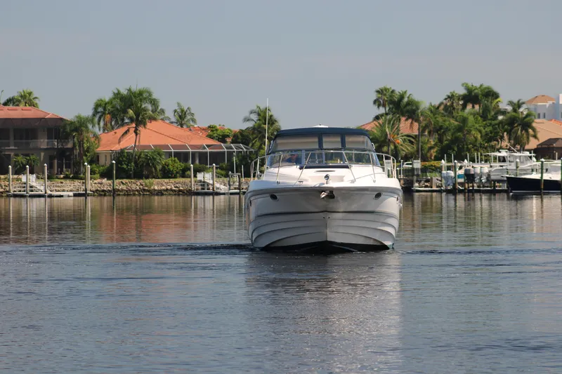 Long Overdue Yacht Photos Pics 2002 Regal Commodore 4260 yacht cruising near waterfront homes and docks.