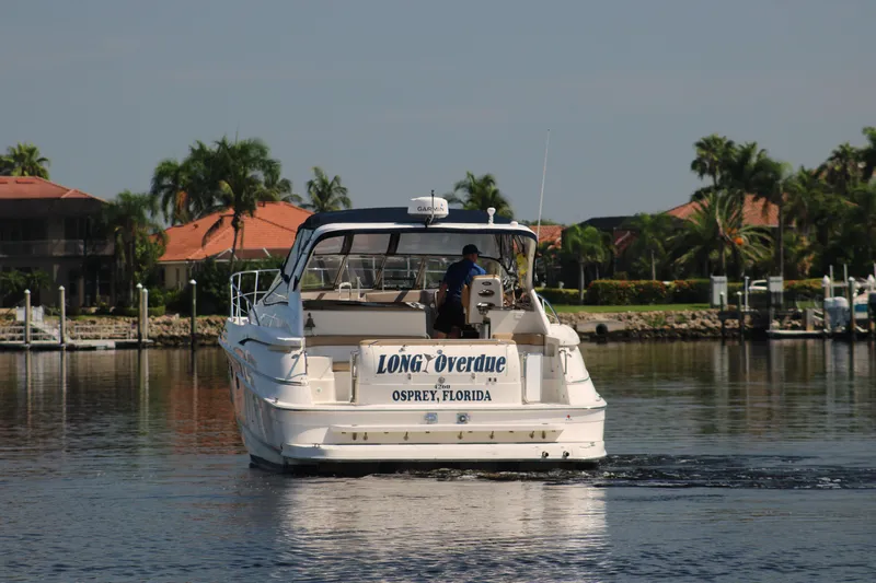 Long Overdue Yacht Photos Pics 2002 Regal Commodore 4260 boat cruising in Florida waters, surrounded by palm trees.