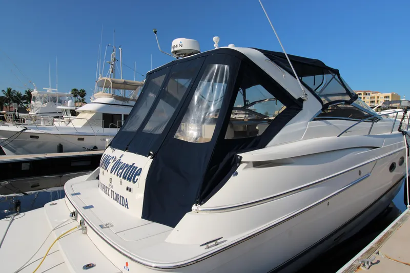 Long Overdue Yacht Photos Pics 2002 Regal Commodore 4260 yacht docked at marina under clear blue sky.