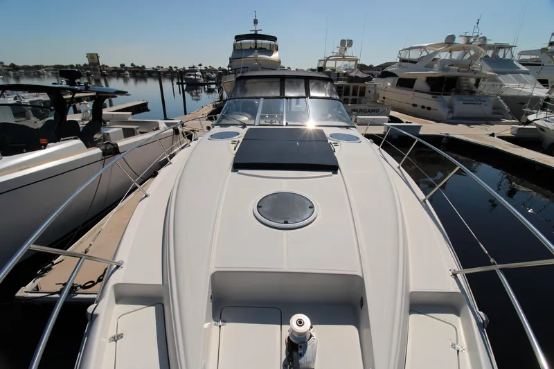 Long Overdue Yacht Photos Pics 2002 Regal Commodore 4260 yacht docked at marina, showcasing sleek design and spacious deck.