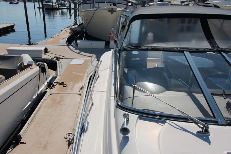 Long Overdue Yacht Photos Pics 2002 Regal Commodore 4260 yacht docked at marina, showcasing sleek design and spacious deck.