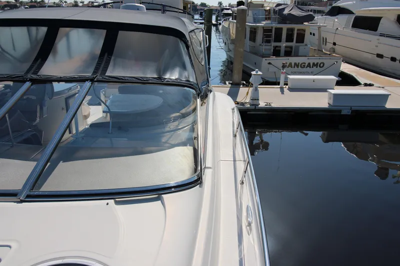Long Overdue Yacht Photos Pics 2002 Regal Commodore 4260 yacht docked at marina, featuring sleek design and spacious deck.