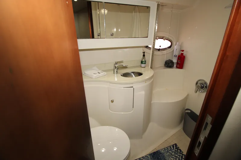 Long Overdue Yacht Photos Pics Bathroom interior of 2002 Regal Commodore 4260 yacht with sink and mirror.
