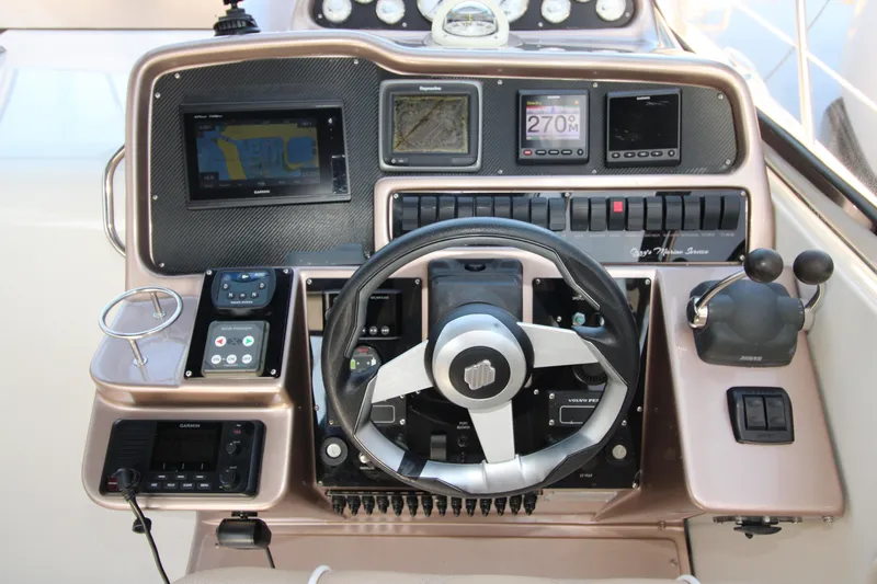 Long Overdue Yacht Photos Pics Control panel of a 2002 Regal Commodore 4260 boat with navigation instruments.