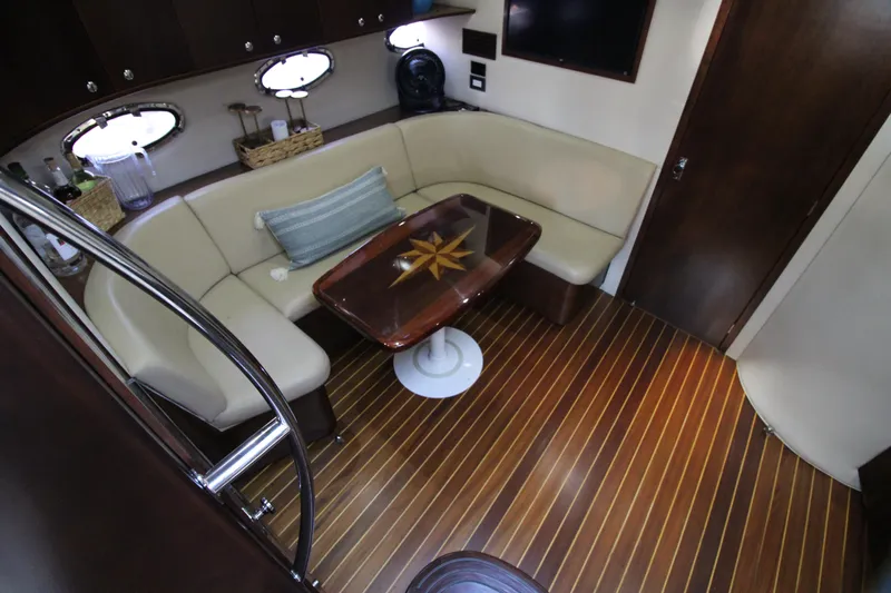 Long Overdue Yacht Photos Pics Interior of 2002 Regal Commodore 4260 yacht with elegant seating and wooden flooring.