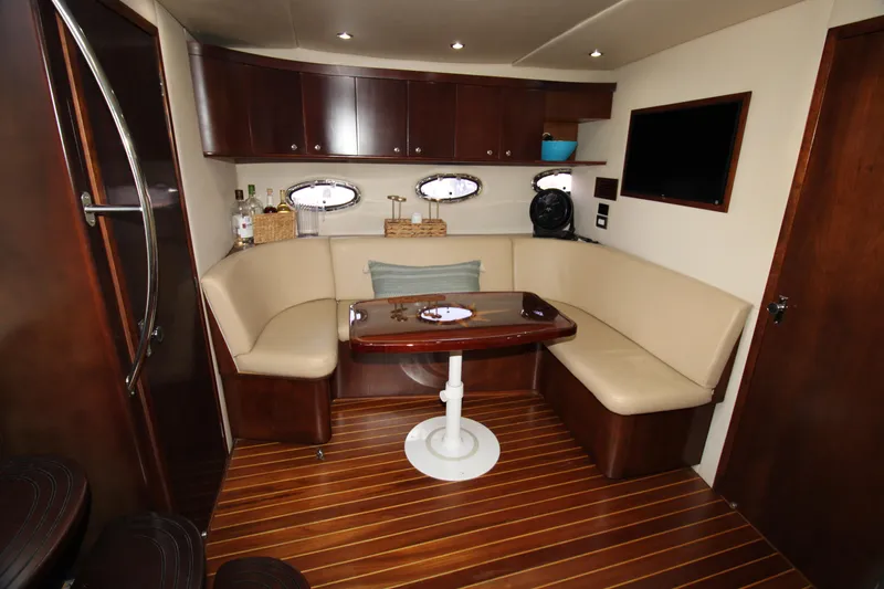 Long Overdue Yacht Photos Pics 2002 Regal Commodore 4260 yacht interior with elegant seating and wooden finishes.