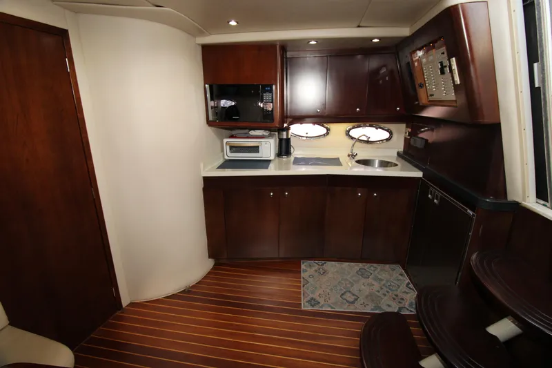 Long Overdue Yacht Photos Pics Luxurious 2002 Regal Commodore 4260 yacht interior with modern kitchen amenities.