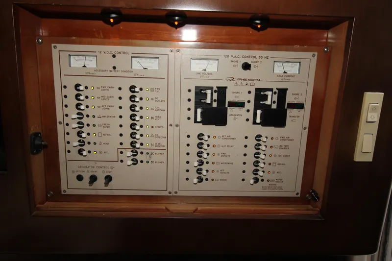 Long Overdue Yacht Photos Pics Electrical control panel of a 2002 Regal Commodore 4260 yacht, featuring various switches and indicators.