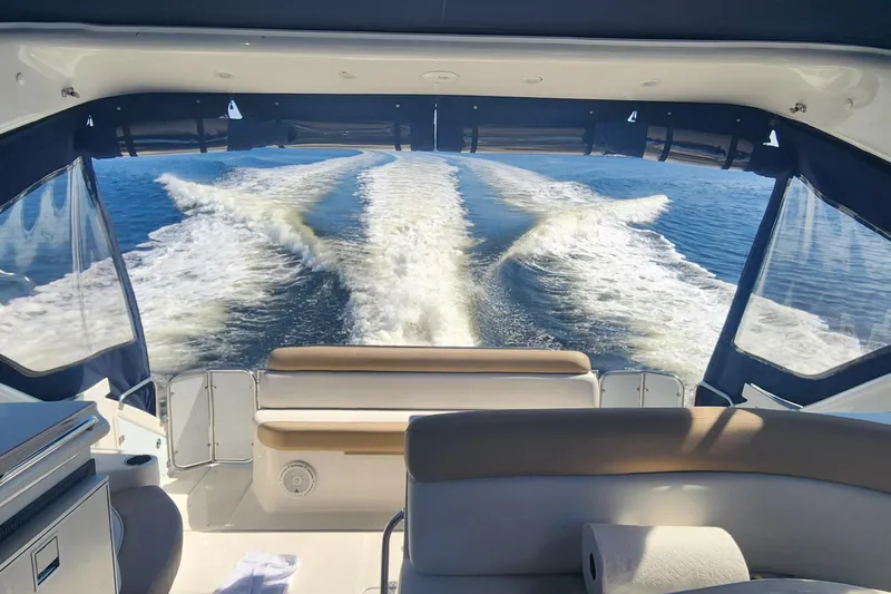 Long Overdue Yacht Photos Pics 2002 Regal Commodore 4260 yacht interior with wake view on open water.