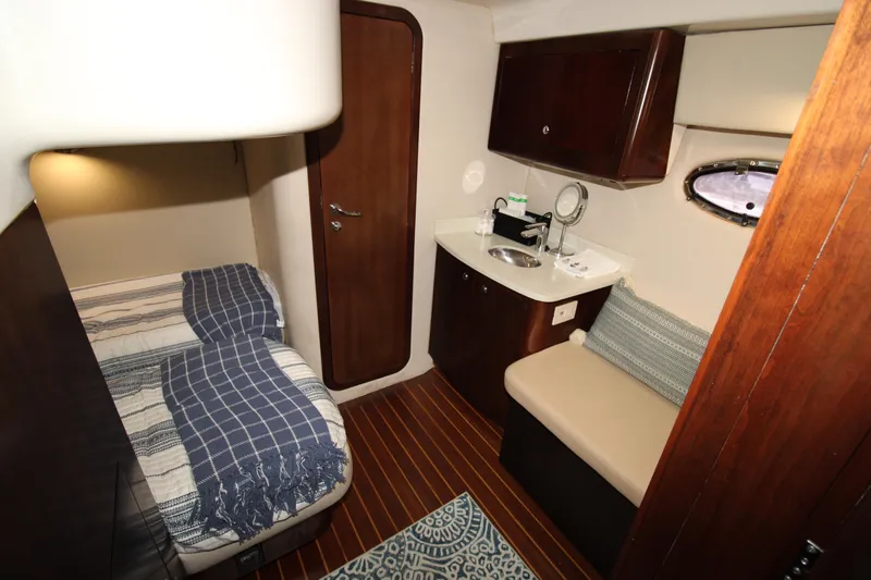 Long Overdue Yacht Photos Pics 2002 Regal Commodore 4260 cabin interior with bed, sink, and seating area.