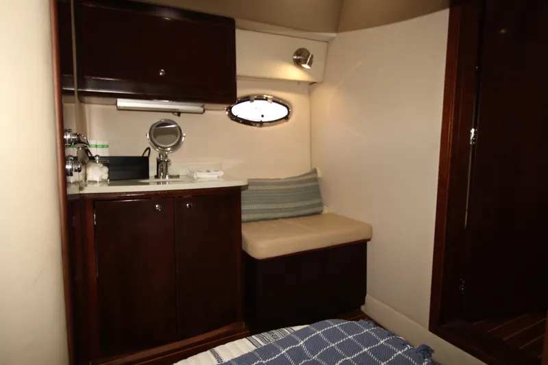 Long Overdue Yacht Photos Pics Luxurious interior of 2002 Regal Commodore 4260 yacht with cozy seating and elegant cabinetry.