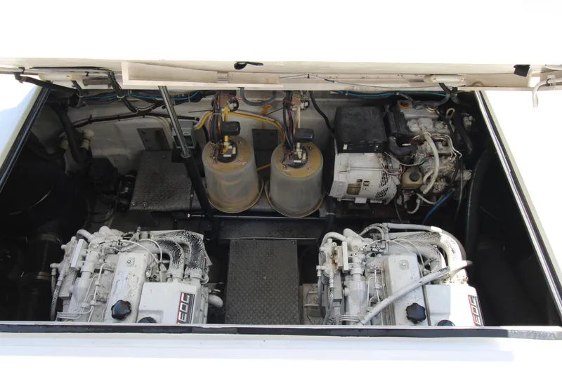 Long Overdue Yacht Photos Pics Engine compartment of 2002 Regal Commodore 4260 yacht, showcasing dual engines and components.