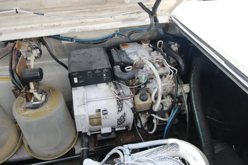 Long Overdue Yacht Photos Pics Engine compartment of a 2002 Regal Commodore 4260 boat, showcasing mechanical components.