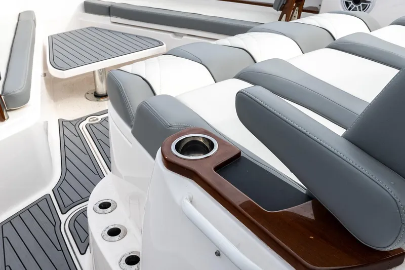 Montrachet Yacht Photos Pics 2023 Everglades 455 Center Console boat interior with cushioned seating and table.