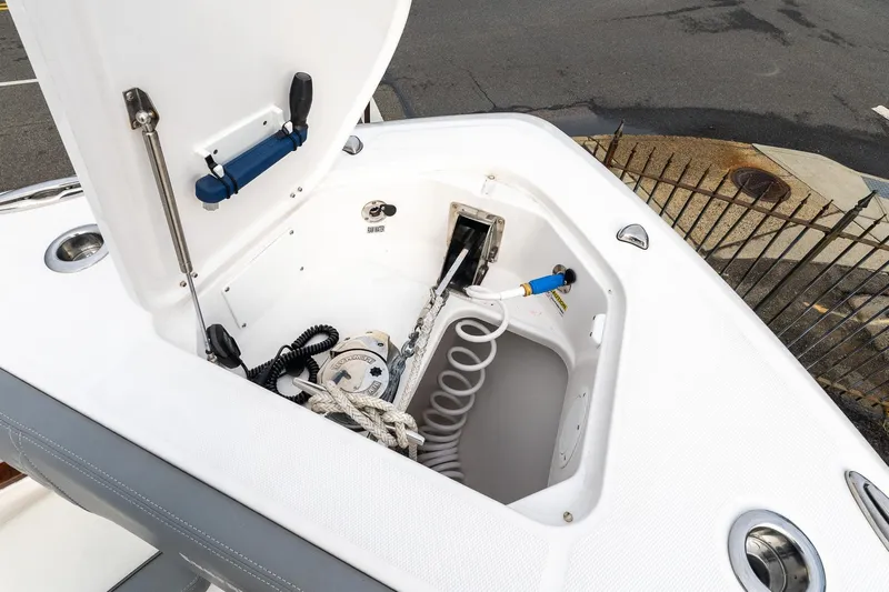 Montrachet Yacht Photos Pics 2023 Everglades 455 Center Console boat storage compartment with coiled hose and equipment.