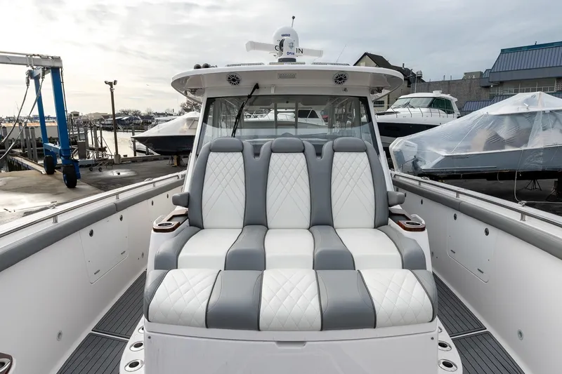 Montrachet Yacht Photos Pics 2023 Everglades 455 Center Console boat with luxurious seating at a marina.