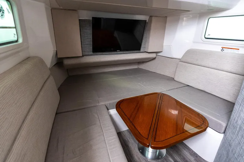 Montrachet Yacht Photos Pics Interior of 2023 Everglades 455 Center Console with cozy seating and wooden table.