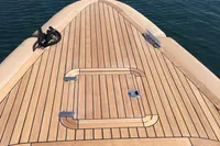 1996 Maxi Custom Tender boat with sleek wooden deck on calm water.