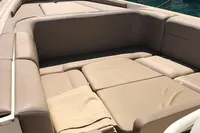 1996 Maxi Custom Tender with beige seating, docked by the waterfront.