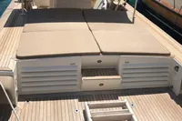 1996 Maxi Custom Tender boat with spacious deck and cushioned seating, docked in a marina.
