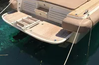 1996 Maxi Custom Tender docked, showcasing rear deck and swim platform.