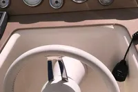 Steering wheel and dashboard of a 1996 Maxi Custom Tender boat.