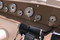 Control panel of a 1996 Maxi Custom Tender boat with gauges and throttle.