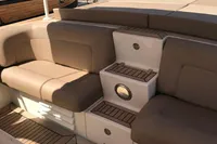 1996 Maxi Custom Tender boat interior with beige seating and wooden flooring.