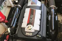 Engine of a 1996 Maxi Custom Tender boat, featuring a 6.2L 350 horsepower motor.