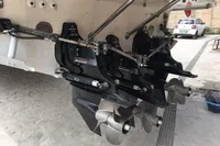 Twin propellers of a 1996 Maxi Custom Tender boat on display.