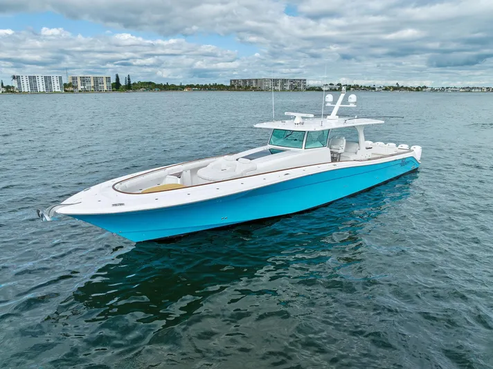 Da Dinghy Yacht Photos Pics 2021 HCB Estrella boat on calm water with cloudy sky background.
