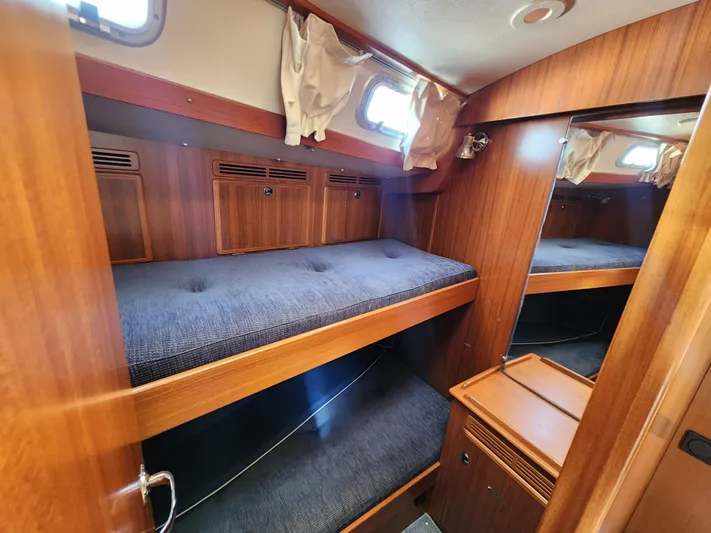Just Do It Yacht Photos Pics 2006 Hallberg-Rassy 53 yacht interior with wooden bunk beds and storage.