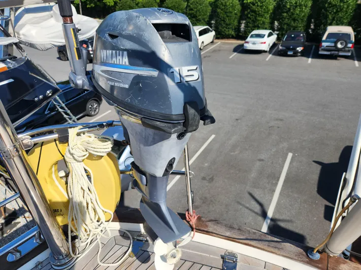 Just Do It Yacht Photos Pics Yamaha 15 outboard motor on 2006 Hallberg-Rassy 53 sailboat, docked in parking lot.