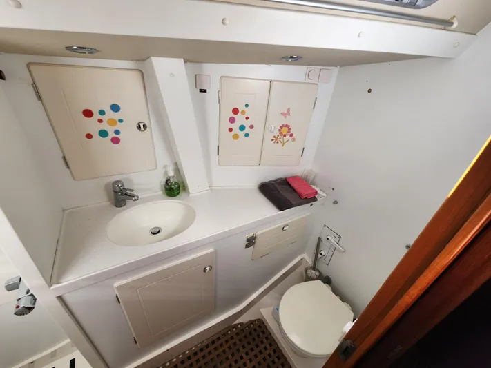 Just Do It Yacht Photos Pics Bathroom interior of 2006 Hallberg-Rassy 53 yacht with colorful cabinet designs.