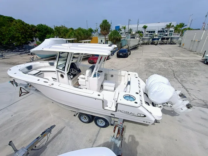 270-152 Yacht Photos Pics 2025 Robalo R270 Center Console boat on trailer in marina setting.