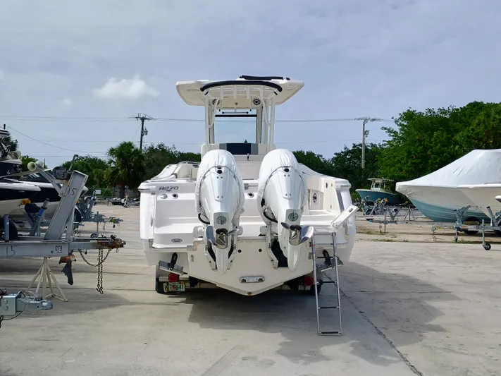 270-152 Yacht Photos Pics 2025 Robalo R270 Center Console boat with dual outboard engines on a trailer.