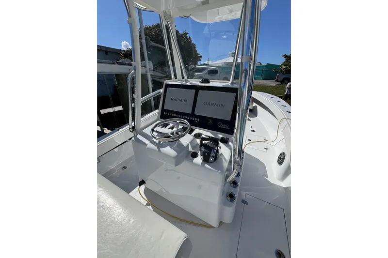  Yacht Photos Pics 2007 Conch 27 boat cockpit with Garmin navigation system and steering wheel.