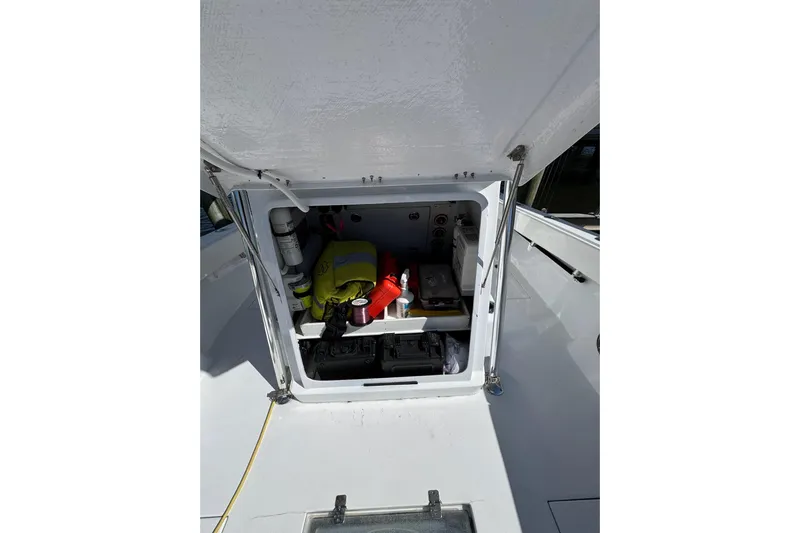  Yacht Photos Pics Open storage compartment on 2007 Conch 27 boat, containing safety and maintenance equipment.