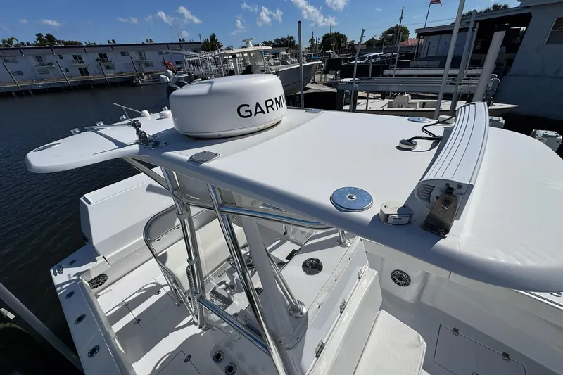  Yacht Photos Pics 2007 Conch 27 boat with Garmin equipment, docked at a marina under clear skies.