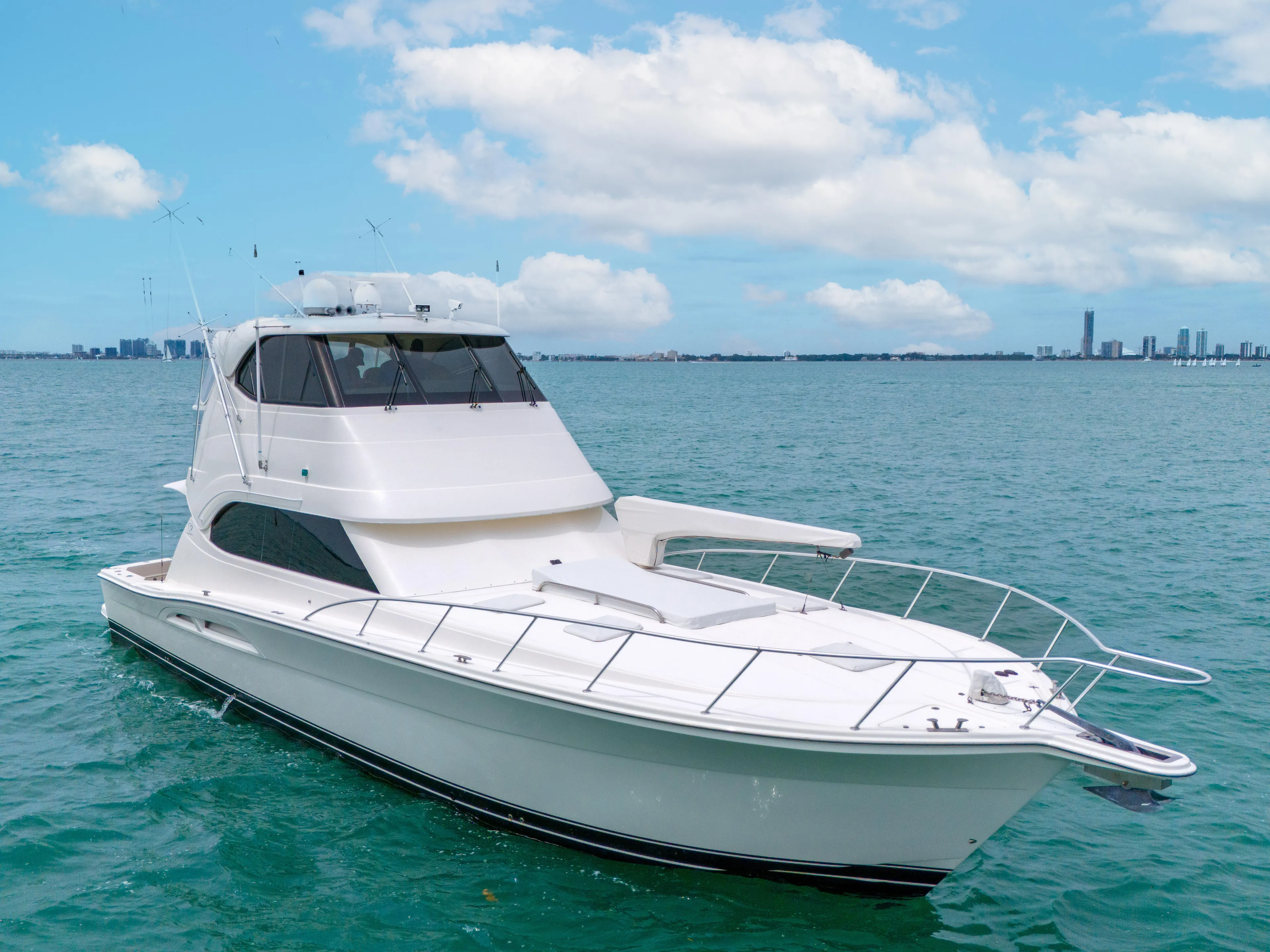  Yacht Photos Pics 2008 Riviera 51 Enclosed Bridge yacht on calm blue water under a partly cloudy sky.