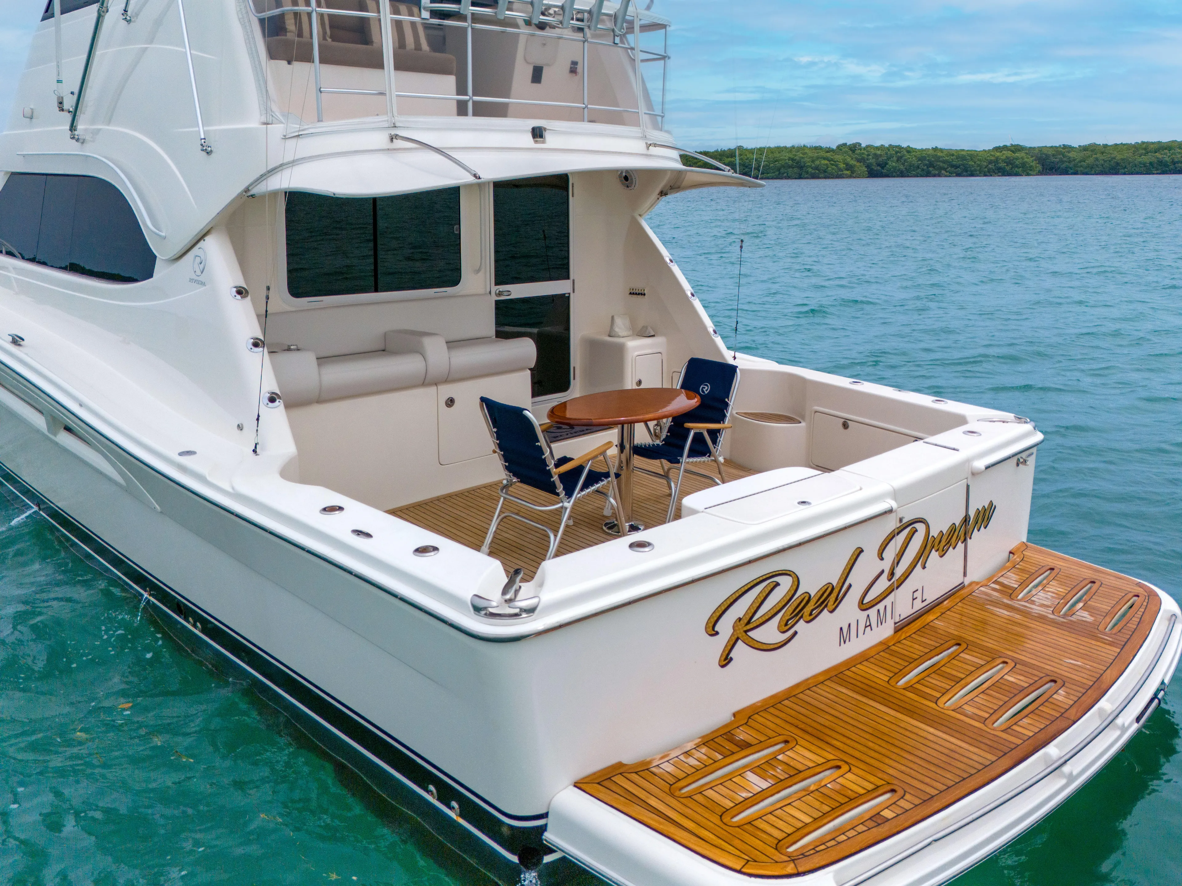  Yacht Photos Pics 2008 Riviera 51 Enclosed Bridge yacht on water, rear view with seating area.