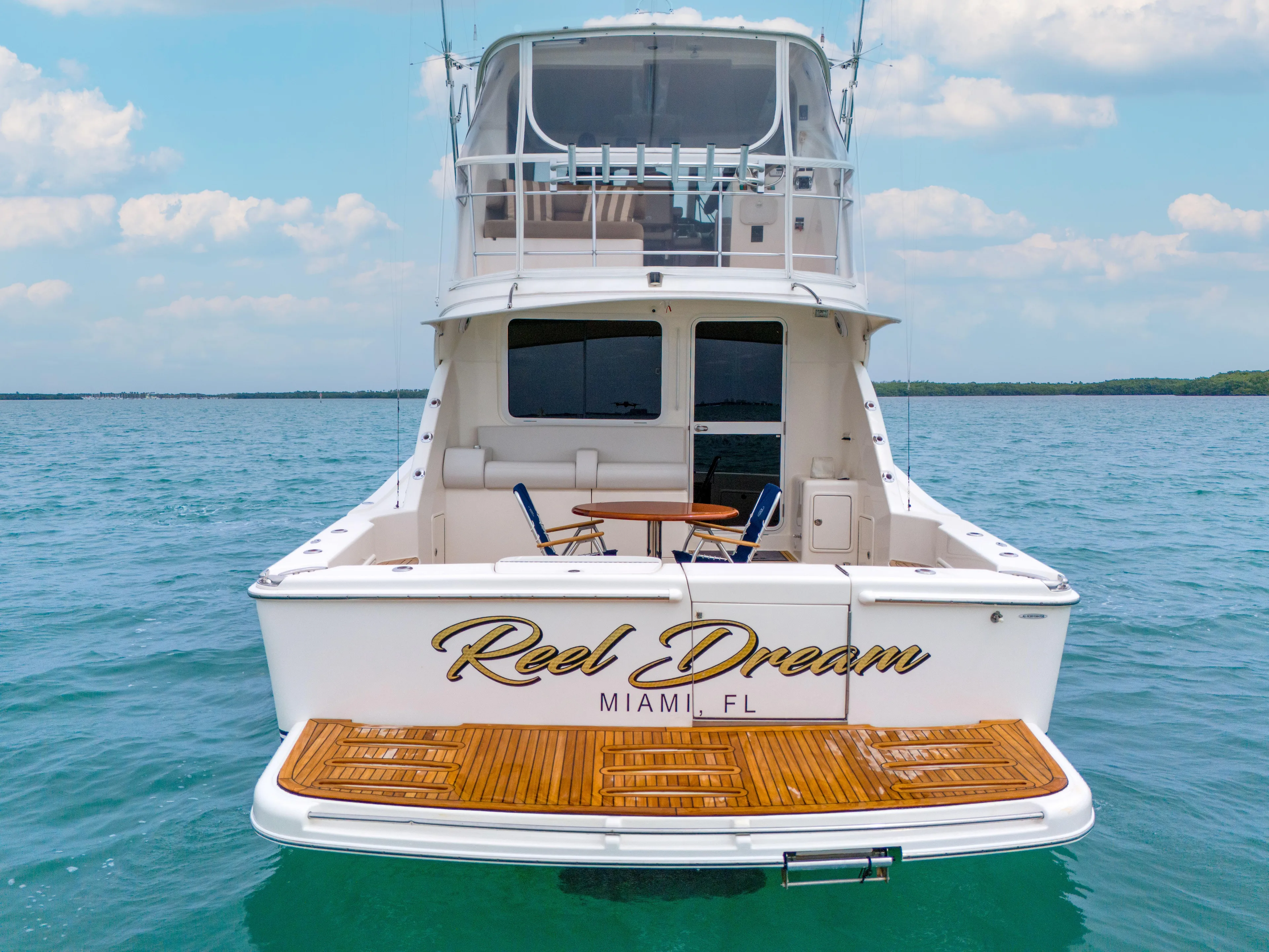 Yacht Photos Pics 2008 Riviera 51 Enclosed Bridge yacht, "Reel Dream," on calm ocean waters, Miami, FL.