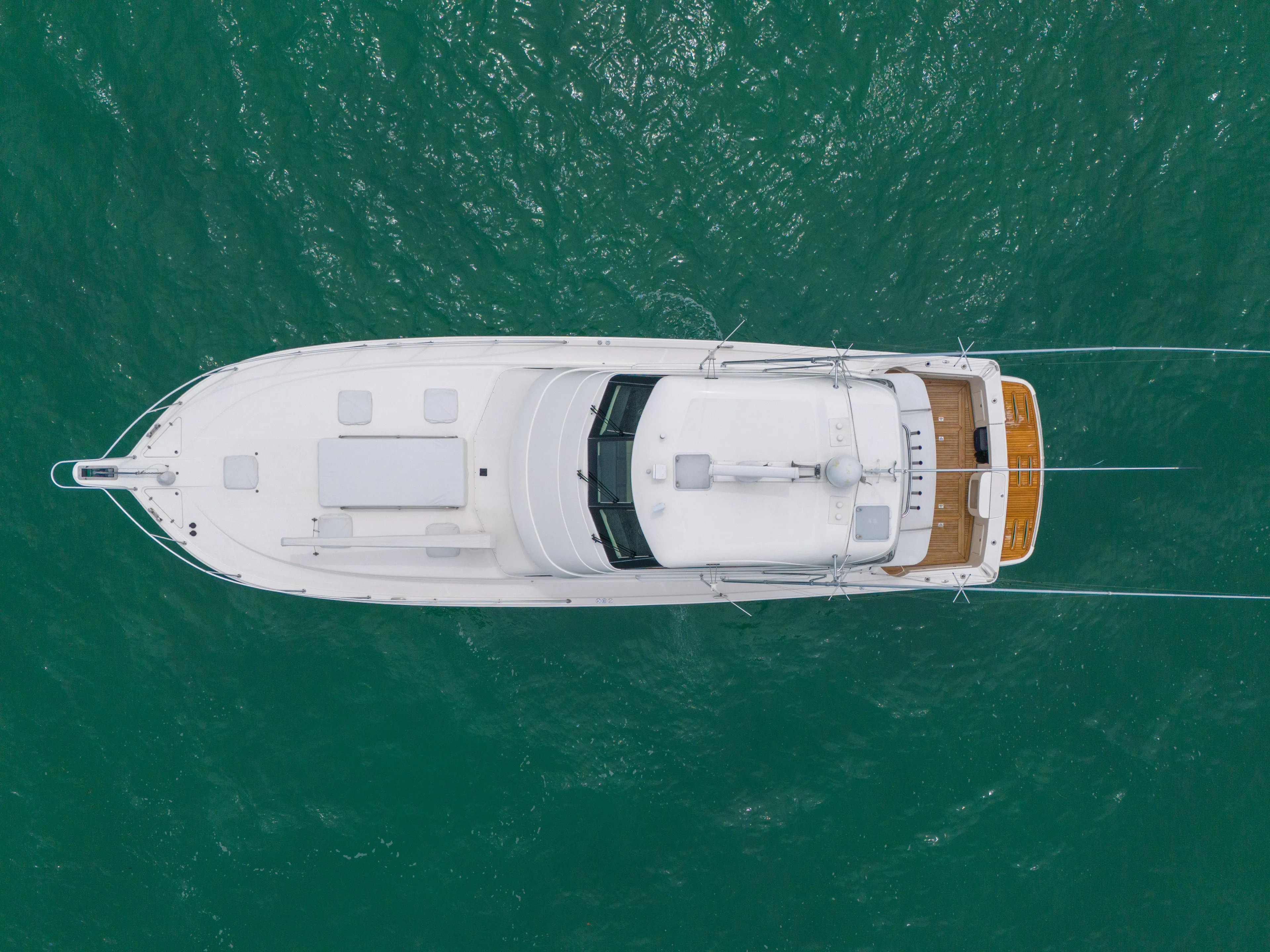  Yacht Photos Pics Aerial view of 2008 Riviera 51 Enclosed Bridge yacht on turquoise water.