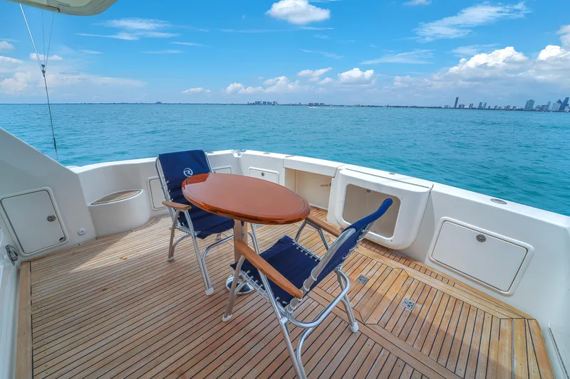  Yacht Photos Pics Luxury yacht deck with chairs and table, Riviera 51 Enclosed Bridge, 2008 model.