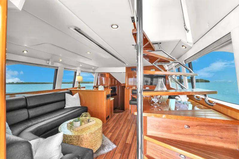  Yacht Photos Pics Luxurious interior of 2008 Riviera 51 Enclosed Bridge yacht with elegant wood finishes.