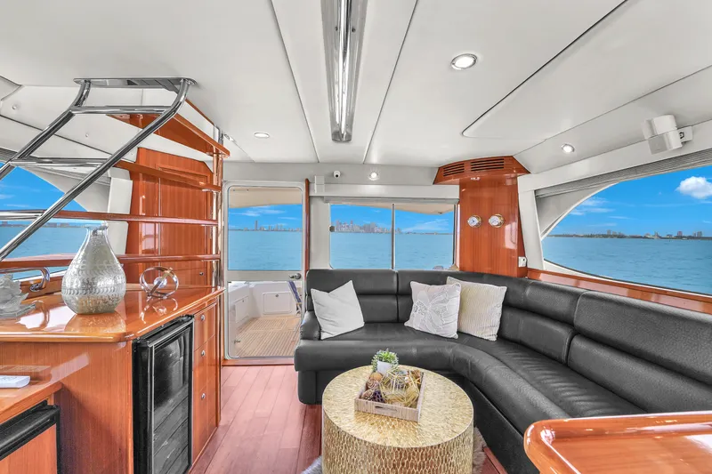  Yacht Photos Pics Luxurious interior of 2008 Riviera 51 Enclosed Bridge yacht with elegant seating and ocean view.