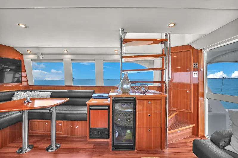  Yacht Photos Pics Luxurious 2008 Riviera 51 Enclosed Bridge yacht interior with elegant wood finishes and ocean view.